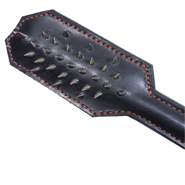 A black leather paddle, plain on one side and sharp metal cones on the other. Has a half inch steel rod for a core.