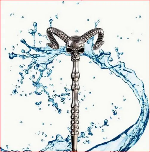 A skull head with horns on a hollow stainless steel rod with water coming out if it's eyes.